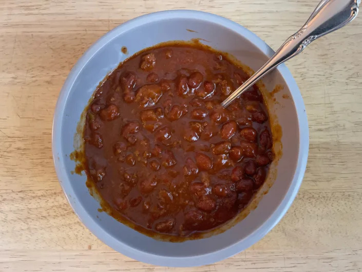 White bowl of Chili with spoon in it