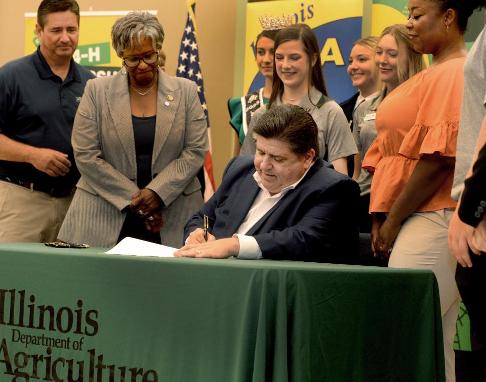 Illinois Gov. JB Pritzker signs a bill Monday, August 14, 2023, that provides Future Farmer's of America or 4-H students excused absents for program related events.