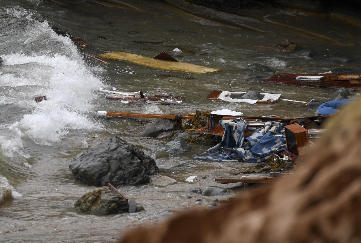 Wreckage and debris washes ashore at Cabrillo National Monument near where a boat capsized just off the San Diego coast Sunday.