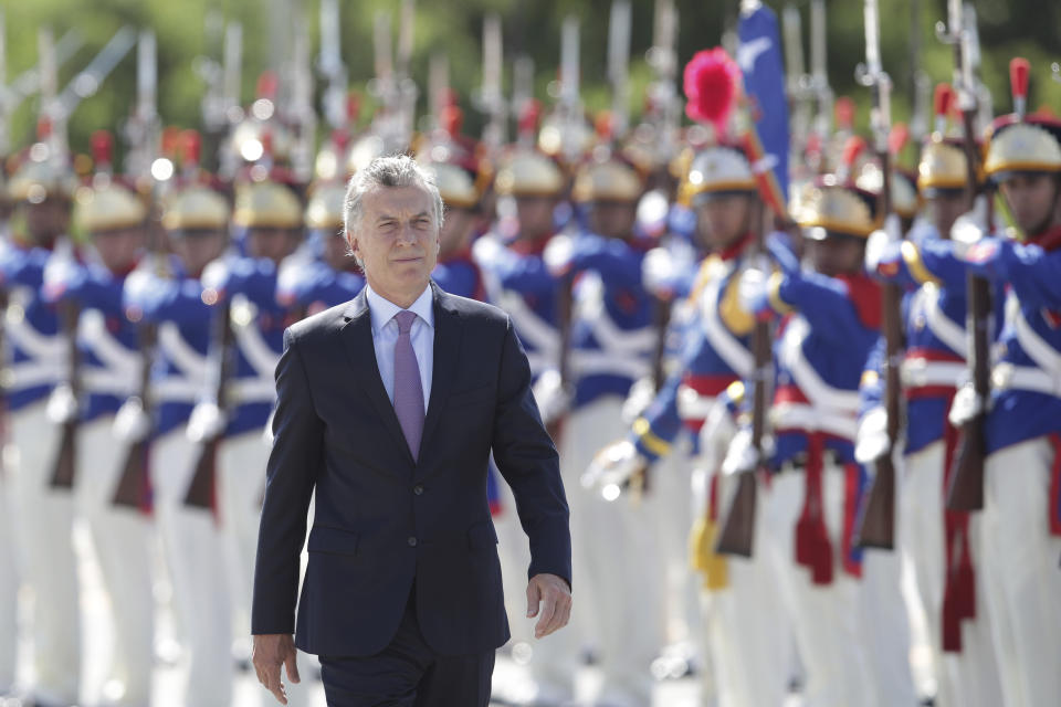 Argentina's President Mauricio Macri receives the military honors during his arrival at the Planalto presidential palace, in Brasilia, Brazil, Wednesday, Jan. 16, 2019. Macri is on a one-day visit to Brazil. (AP Photo/Eraldo Peres)