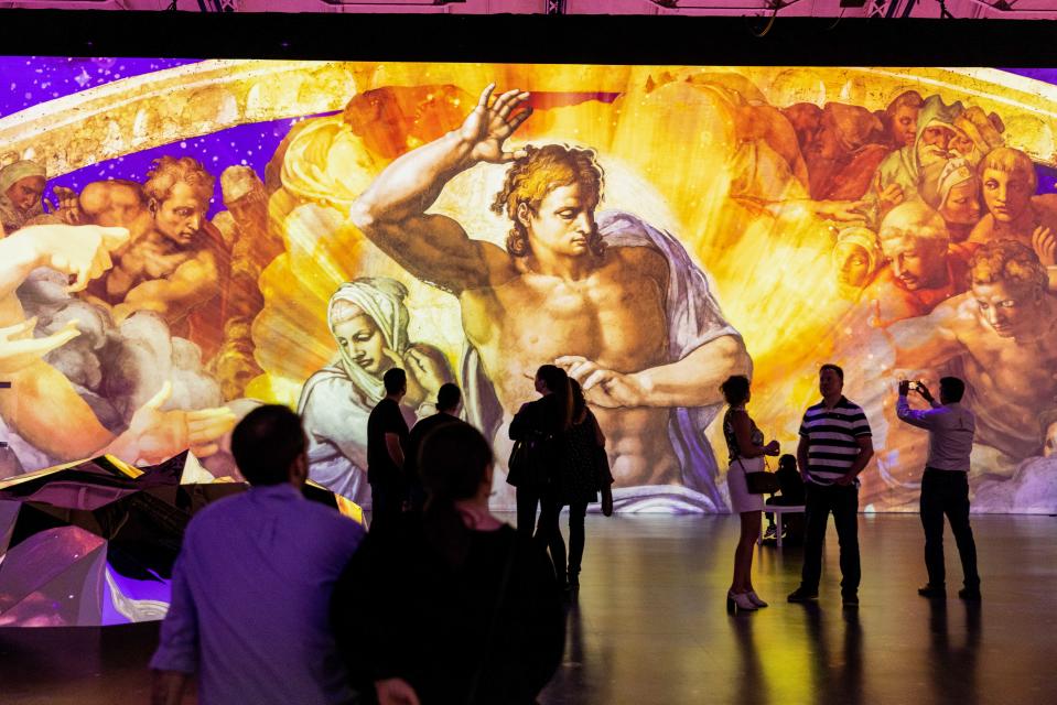Visitors explore "The Last Judgement" by Michelangelo at "Immersive Vatican."