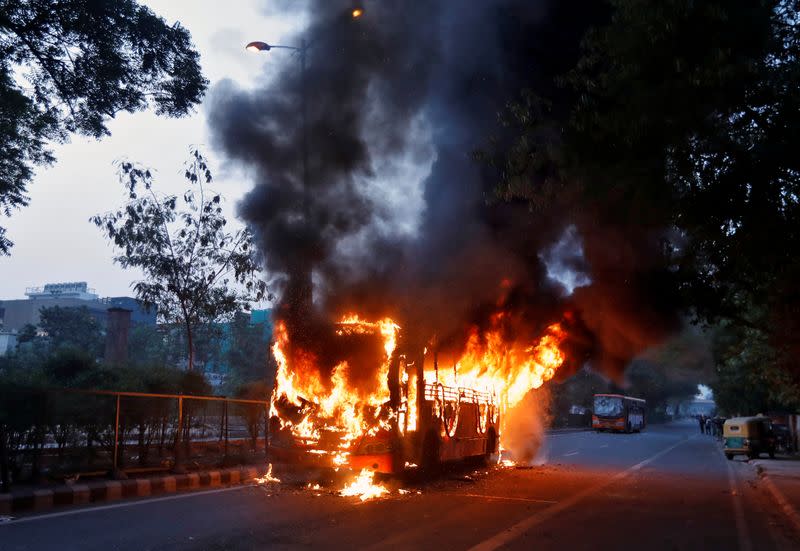 Passenger bus burns during a protest against a new citizenship law, in New Delhi
