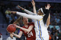 Stanford's Lacie Hull (24) passes around UCLA's Lauryn Miller, right, during the second half of an NCAA college basketball game in the semifinal round of the Pac-12 women's tournament Saturday, March 7, 2020, in Las Vegas. (AP Photo/John Locher)