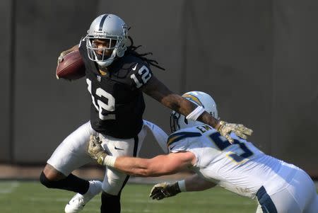 FILE PHOTO: Nov 11, 2018; Oakland, CA, USA; Oakland Raiders wide receiver Martavis Bryant (12) is defended by Los Angeles Chargers outside linebacker Kyle Emanuel (51) in the first quarterat Oakland-Alameda County Coliseum. Mandatory Credit: Kirby Lee-USA TODAY Sports