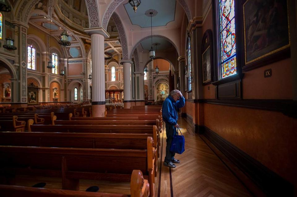 Dick Jones, 66, of Sacramento, finds comfort as he prays at the stations of the cross on Friday, April 3, 2020, during the coronavirus pandemic at the Cathedral of the Blessed Sacrament in downtown Sacramento.