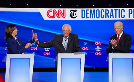 Democratic presidential candidate Harris high fives Sanders during during the fourth U.S. Democratic presidential candidates 2020 election debate at Otterbein University in Westerville, Ohio U.S.
