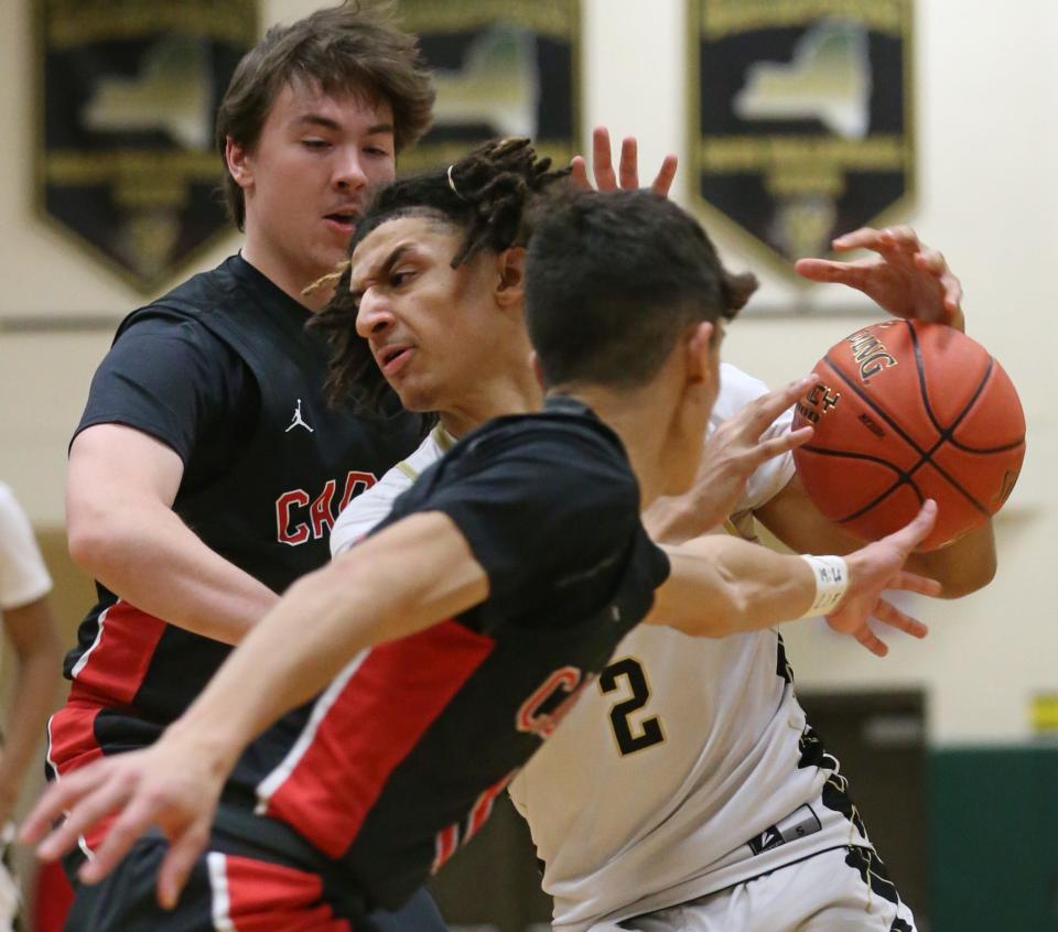 Rush-Henrietta's Graylin Strong drives to the basket but has the ball knocked away by Hilton's Brady Gerig.