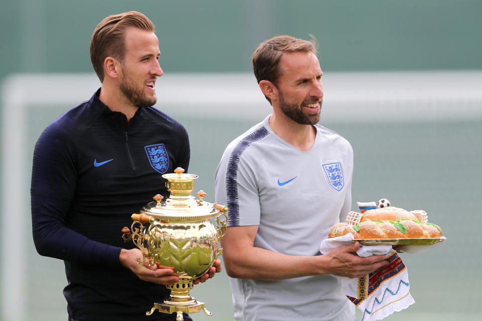 England’s Harry Kane (left) and manager Gareth Southgate receive a Russian samovar – a heated metal container traditionally used to heat and boil water, and a karavai – a large round loaf of bread. (PA)