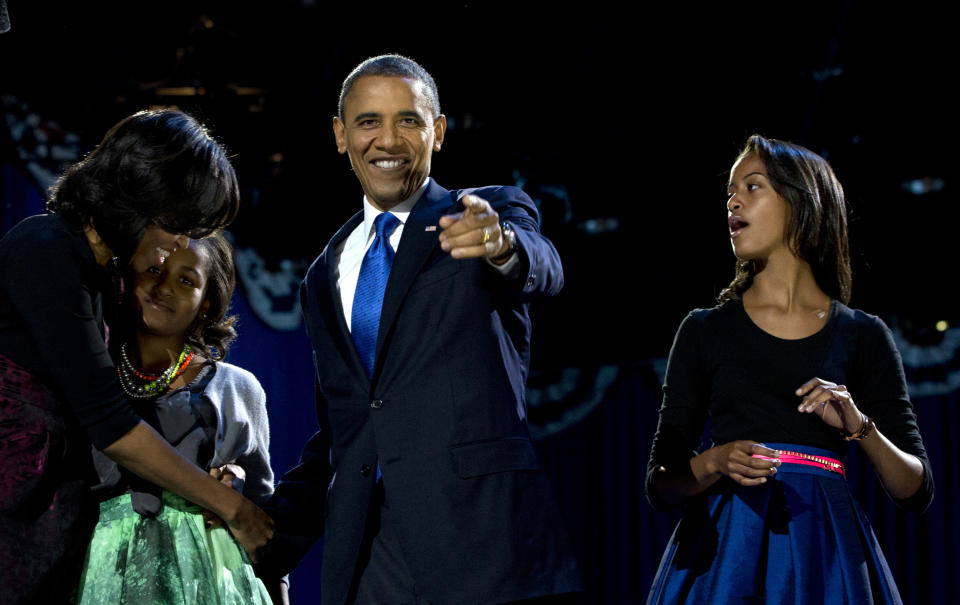 President Barack Obama, accompanied by first last Michelle Obama and daughters Malia and Sasha arrive at the election night party Wednesday, Nov. 7, 2012, in Chicago. Obama defeated Republican challenger former Massachusetts Gov. Mitt Romney. (AP Photo/Carolyn Kaster)