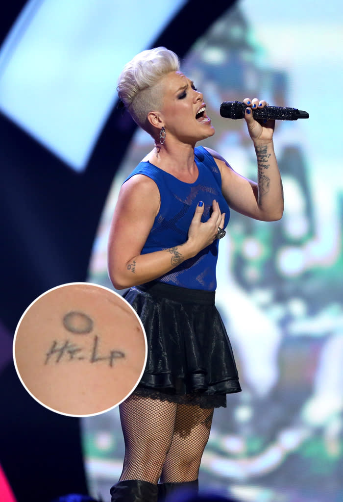 Pink is covered with tats, most of which have special meaning to her, including a portrait of her late bulldog Elvis. However, she has one piece of body art that she clearly decided to get during a fleeting moment: the word “Help” scrawled on her right forearm, along with a circle that is supposed to represent a button. The singer has joked that she got it during “a really brilliant moment of clarity” with her friend, musician Butch Walker (he has a matching tattoo). We can only imagine how many people walk up to Pink and push her “button" just to annoy her.