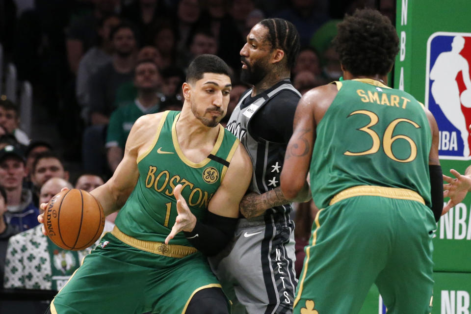 Boston Celtics center Enes Kanter (11) drives against Brooklyn Nets forward Wilson Chandler (21) during the first half of an NBA basketball game Tuesday, March 3, 2020, in Boston. (AP Photo/Mary Schwalm)