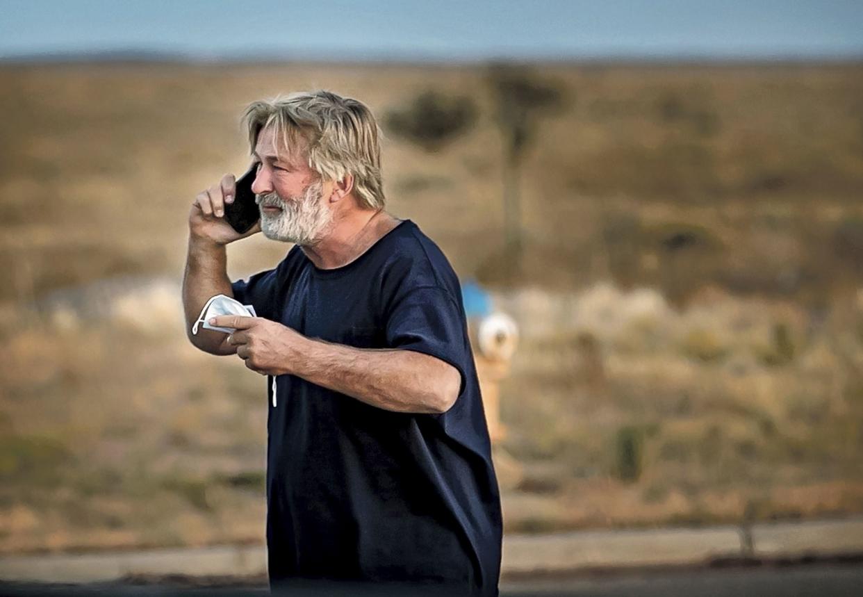 Alec Baldwin speaks on the phone in the parking lot outside the Santa Fe County Sheriff's Office in Santa Fe, N.M., after he was questioned about a shooting on the set of the film "Rust" on the outskirts of Santa Fe, Thursday, Oct. 21, 2021.