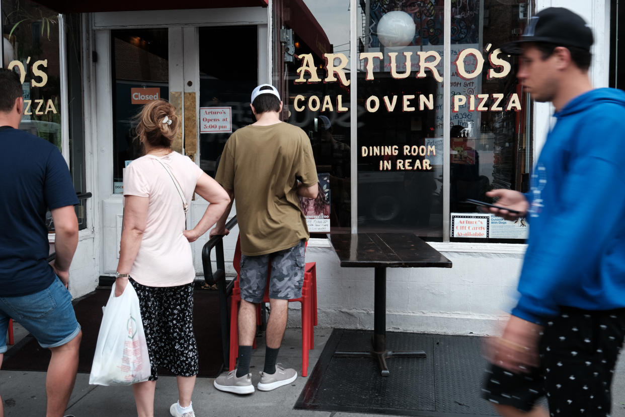 People wait outside of Arturo's, a famed Greenwich Village restaurant that makes coal-oven pizzas.