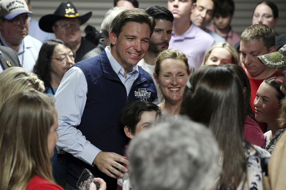 Florida Gov. Ron DeSantis poses for a picture with voters after giving a speech at a rally in Council Bluffs, Iowa, Wednesday. Several hundred people filled half of an event center to listen to DeSantis speak in his first trip to Iowa since announcing his presidential campaign. (AP Photo/Josh Funk)