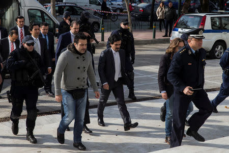 The eight Turkish soldiers, who fled to Greece in a helicopter and requested political asylum after a failed military coup against the government, are escorted by police officers as they arrive at the Supreme Court in Athens, Greece, January 23, 2017. REUTERS/Alkis Konstantinidis