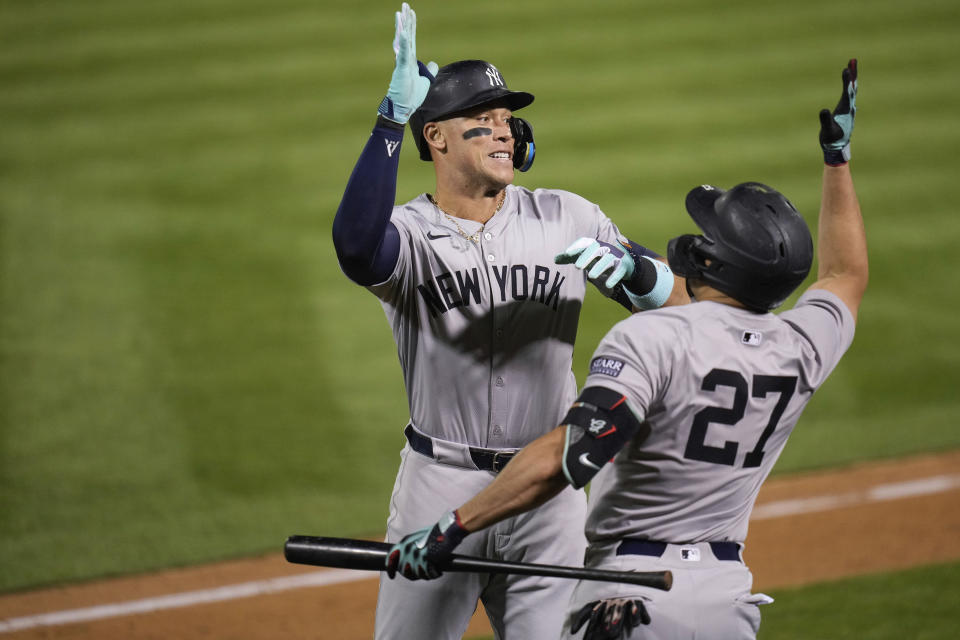 New York Yankees' Aaron Judge, left, celebrates with Giancarlo Stanton (27) after hitting a solo home run during the seventh inning of a baseball game against the Oakland Athletics, Saturday, Sept. 21, 2024, in Oakland, Calif. (AP Photo/Godofredo A. Vásquez)