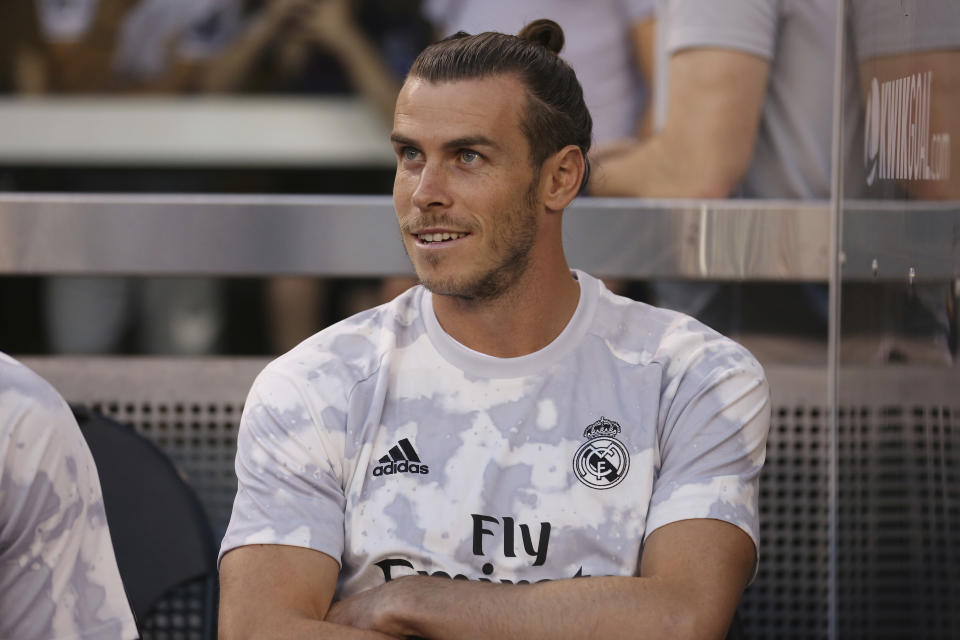 Real Madrid forward Gareth Bale sits on the bench before the first half of an International Champions Cup soccer match against Atletico Madrid, Friday, July 26, 2019, in East Rutherford, N.J. Atletico Madrid won 7-3. (AP Photo/Steve Luciano)