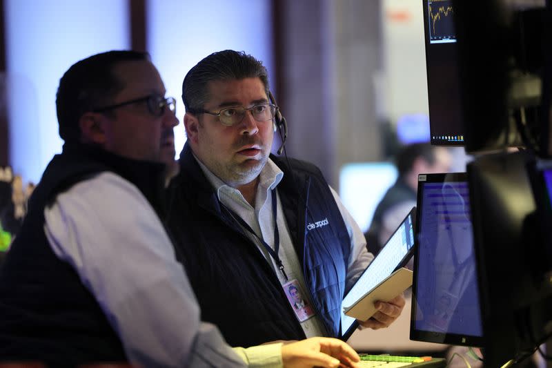 Traders work on the floor of the NYSE in New York