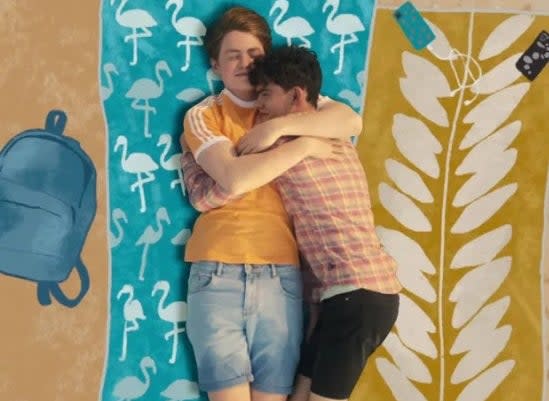 Nick (Kit Connor) and Charlie (Joe Lock) embrace on the beach