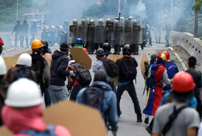 Opposition activists clash with riot police during a protest against Venezuelan President Nicolas Maduro, in Caracas on May 3, 2017