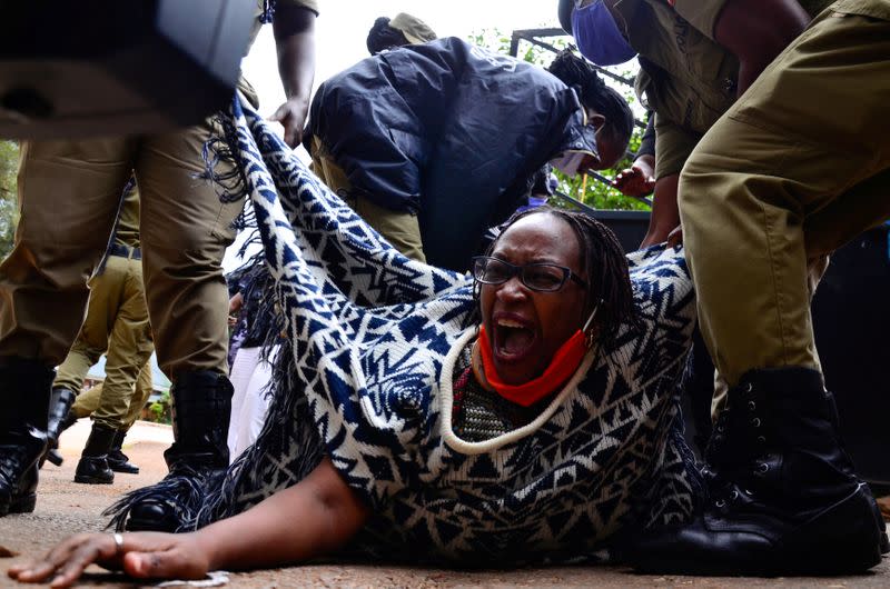 Ugandan academic Stella Nyanzi reacts as police officers detain her for protesting against the way that government distributes the relief food and the lockdown situation to control the spread of the coronavirus disease (COVID-19) outbreak in Kampala