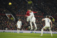 Manchester United's Marcus Rashford, top left, heads the ball to score his sides first goal during the English Premier League soccer match between Manchester United and Leeds United at Old Trafford in Manchester, England, Wednesday, Feb. 8, 2023. (AP Photo/Dave Thompson)