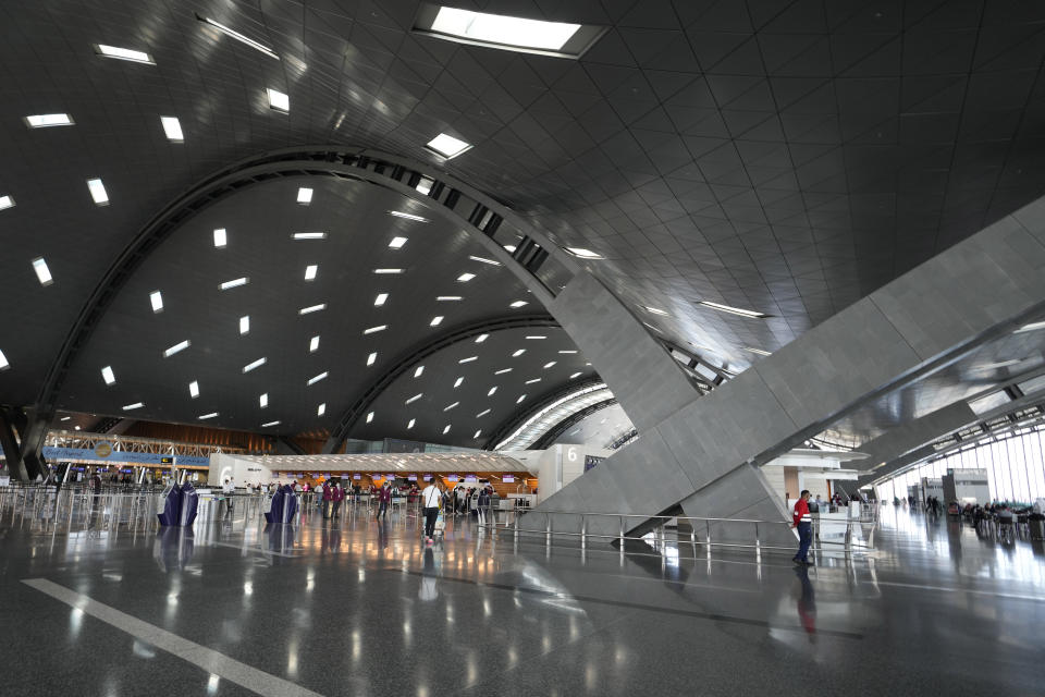 FILE - Passengers walk at Hamad International Airport in Doha, Qatar, Thursday, Nov. 10, 2022. (AP Photo/Hassan Ammar, File)