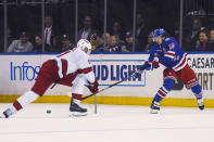 Carolina Hurricanes center Jordan Staal (11) defends against New York Rangers left wing Artemi Panarin (10) during the second period of an NHL hockey game Tuesday, April 12, 2022, in New York. (AP Photo/Bebeto Matthews)