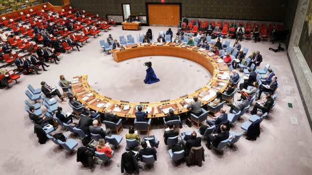 People sitting on chairs in a circular arrangement.