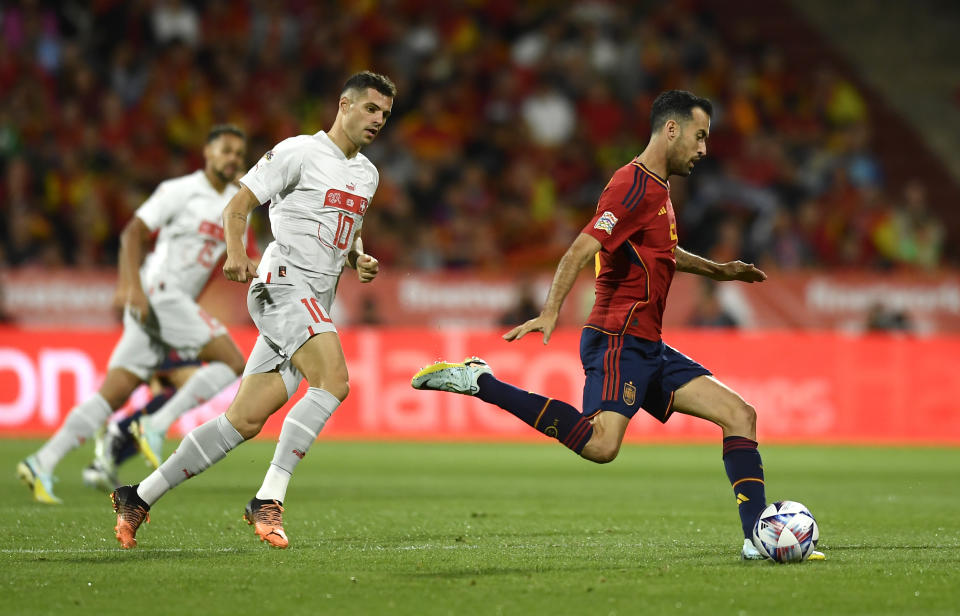 FILE - Spain's Sergio Busquets, right, controls the ball ahead Switzerland's Granit Xhaka during the UEFA Nations League soccer match between Spain and Switzerland, at the Benito Villamarin Stadium, in Seville, Spain, Saturday, Sept. 24, 2022. (AP Photo/Jose Breton, File)