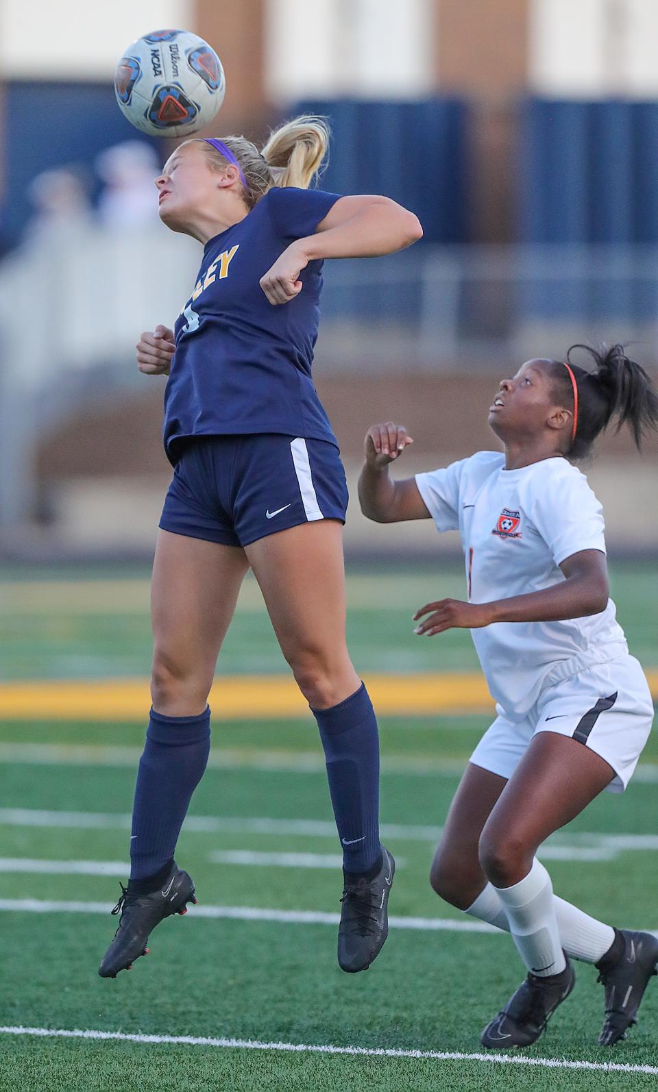 Copley's Gabby Niemczura heads the ball in front of Green's Alaina Bradford on Monday, Sept. 12, 2022 in Copley.