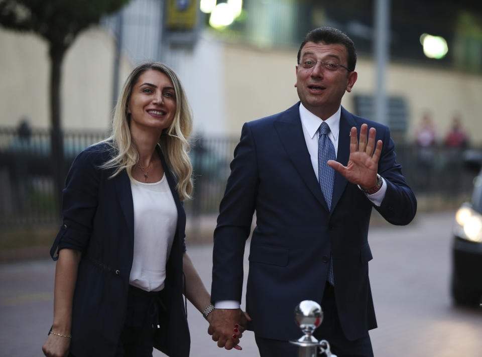 Istanbul's mayoral candidate Ekrem Imamoglu, candidate of the secular opposition Republican People's Party, or CHP, accompanied by his wife, name not given, arrives for a televised debate with Binali Yildirim, of Turkey's ruling Justice and Development Party, or AKP, ahead of the June 23 re-run of Istanbul elections, Sunday, June 16, 2019. Televised election debates are uncommon in Turkey. The last one, between AKP leader Recep Tayyip Erdogan and the then-leader of the CHP, took place before a 2002. The AKP has been in power since. (AP Photo/Emrah Gurel)