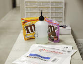 An unused test specimen bag sits at an employee station at Primary Health Medical Group's clinic in Boise, Idaho, Tuesday, Nov. 24, 2020. Troops direct people outside the urgent-care clinic revamped into a facility for coronavirus patients as infections and deaths surge in Idaho and nationwide. Some 1,000 people have died due to COVID-19, and infections this week surpassed 100,000. (AP Photo/Otto Kitsinger)