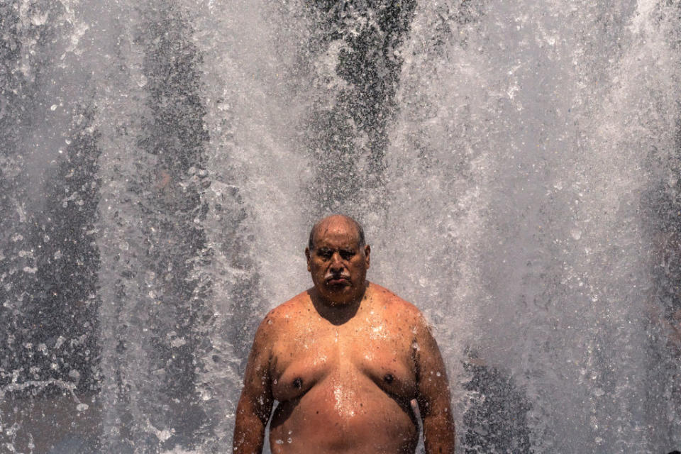 Pablo Miranda cools off in the Salmon Springs Fountain on June 27, 2021 in Portland, Oregon.<span class="copyright">Nathan Howard—Getty Images</span>