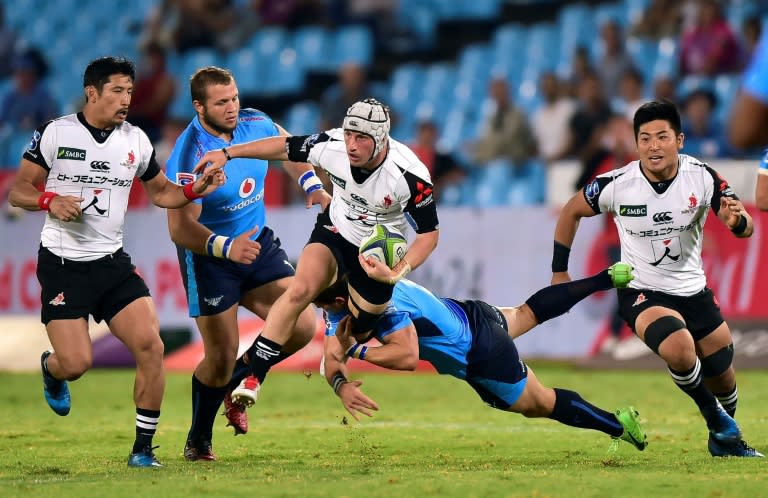 Piet van Zyl (R) of the Blue Bulls tackles Hayden Cripps of the Sunwolves during their Super Rugby match, at Loftus Versfeld Stadium in Pretoria, South Africa, on March 17, 2017