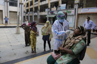 A health worker takes a nasal swab sample to test for COVID-19 outside a bank in Ahmedabad, India, Thursday, Sept. 10, 2020. India's coronavirus cases are now the second-highest in the world and only behind the United States. (AP Photo/Ajit Solanki)