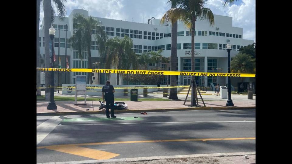 The scooter hit by a driver can be seen on the sidewalk in front of the Miami Beach Police Department headquarters.