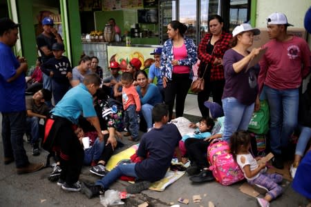 Mexican citizens fleeing violence, queue to cross into the U.S. to apply for asylum at Paso del Norte border crossing bridge in Ciudad Juarez