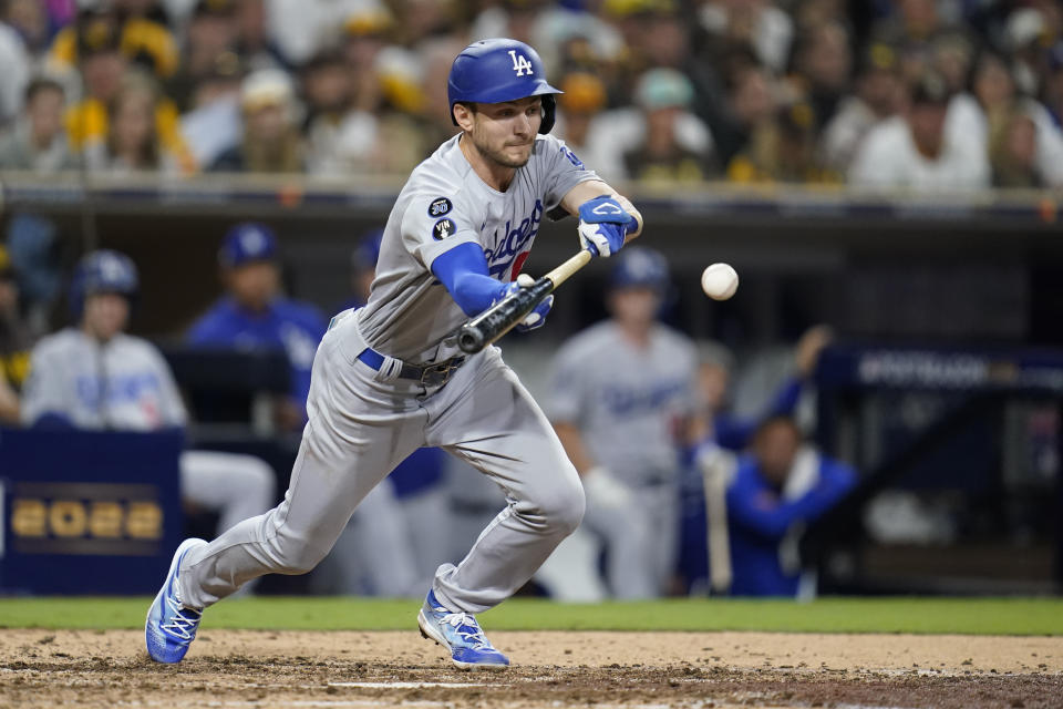 Los Angeles Dodgers' Trea Turner hits a bunt single during the seventh inning in Game 4 of a baseball NL Division Series against the Los Angeles Dodgers, Saturday, Oct. 15, 2022, in San Diego. (AP Photo/Ashley Landis)