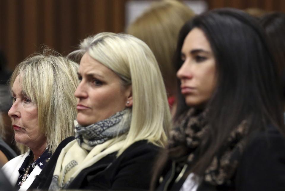 June Steenkamp (L), mother of Reeva Steenkamp, watches with family friends as Olympic and Paralympic track star Oscar Pistorius speaks in the North Gauteng High Court in Pretoria, April 11, 2014. Pistorius is on trial for murdering his girlfriend Reeva Steenkamp at his suburban Pretoria home on Valentine's Day last year. REUTERS/Themba Hadebe/Pool (SOUTH AFRICA - Tags: SPORT ATHLETICS CRIME LAW)