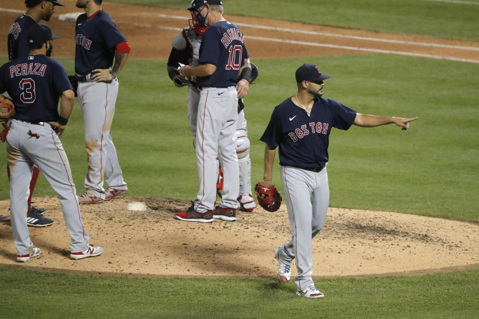Boston Red Sox starting pitcher Martin Perez, right, gestures as he leaves the game during the sixth inning of the baseball game against the New York Mets at Citi Field, Thursday, July 30, 2020, in New York. (AP Photo/Seth Wenig)