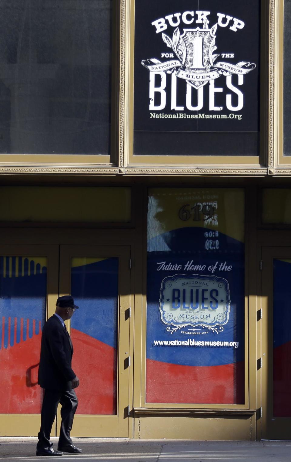 In this Wednesday, Sept. 25, 2013 photo, a man walks past past the site of the National Blues Museum, set to open next year, in St. Louis. Casual Blues fans may not immediately think of St. Louis when considering the genre, but organizers of the project say the city has its own rich musical history making it a deserving home for the national museum. (AP Photo/Jeff Roberson)