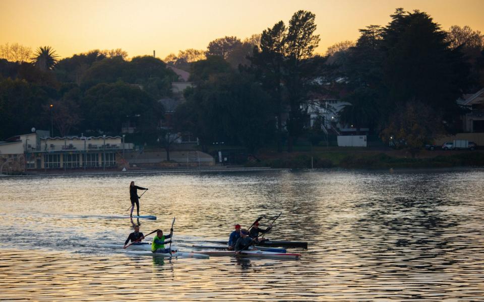 Canoeists row in the early morning on the waters of the Emmarencia Dam, Johannesburg - SHUTTERSTOCK