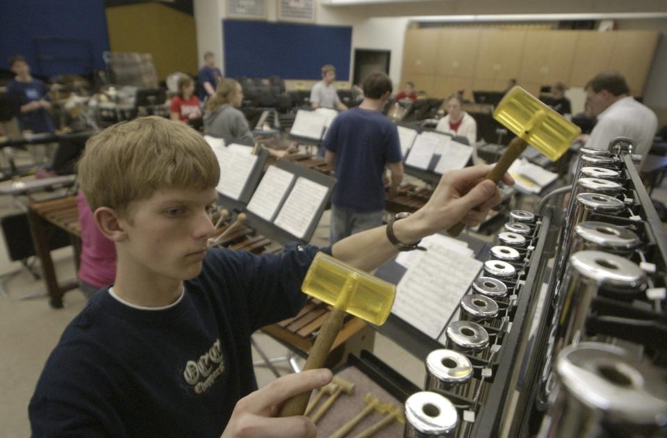 Miles McGee, 17, plays the bells during practice with the Lancaster High School Percussion Ensemble, inside the high school, in Lancaster, Ohio, on Monday, April 12, 2004. The group will travel to San Francisco for a concert.