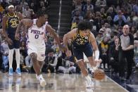 Indiana Pacers' Andrew Nembhard (2) makes a steal against Philadelphia 76ers' Tyrese Maxey (0) during the first half of an NBA basketball game, Monday, March 6, 2023, in Indianapolis. (AP Photo/Darron Cummings)