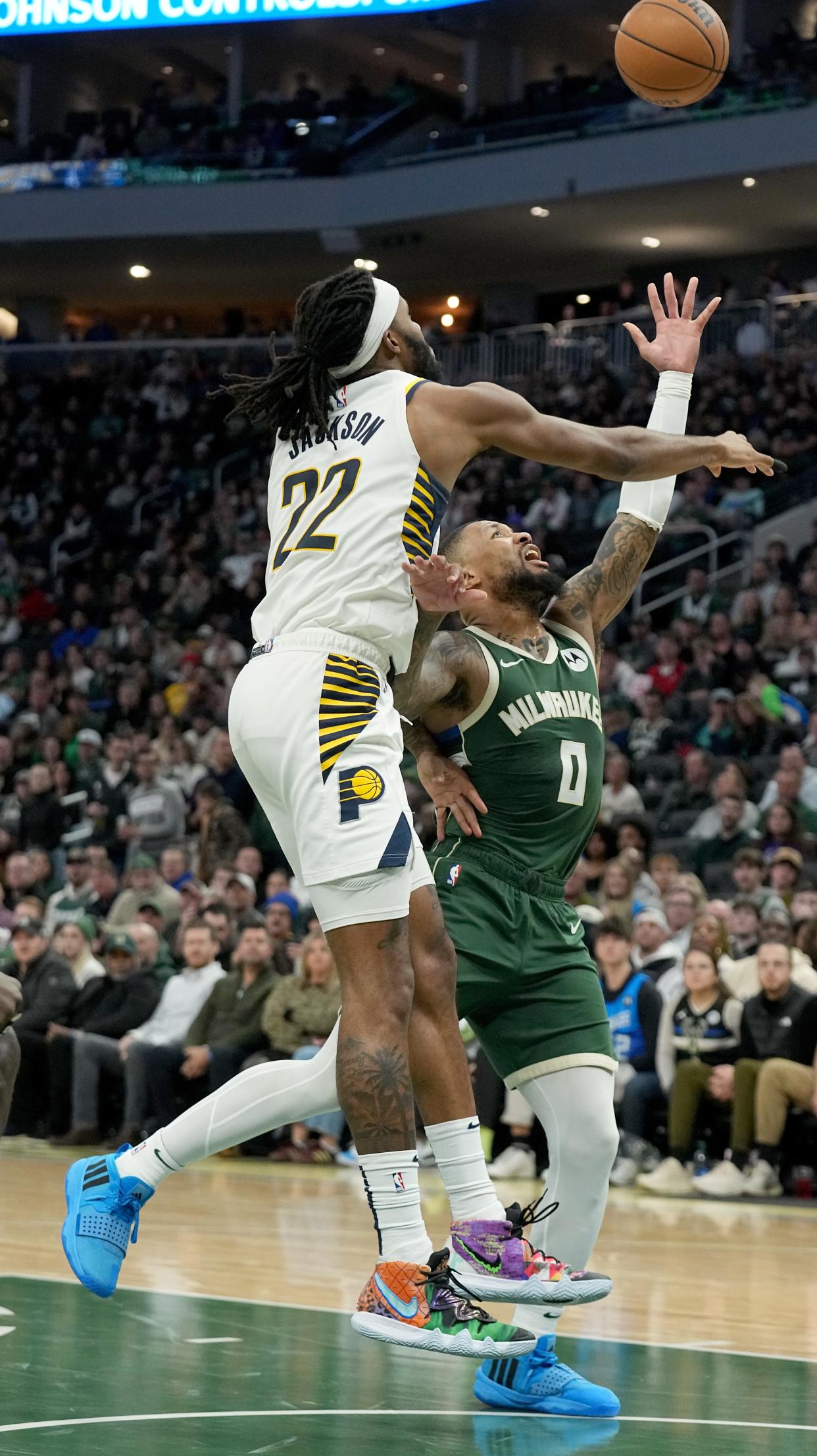 Indiana Pacers' Isaiah Jackson (22) prevents Milwaukee Bucks guard Damian Lillard (0) from scoring during the second half of their game Monday, January 1, 2024 at Fiserv Forum in Milwaukee, Wisconsin. The Indiana Pacers beat the Milwaukee Bucks 122-113.