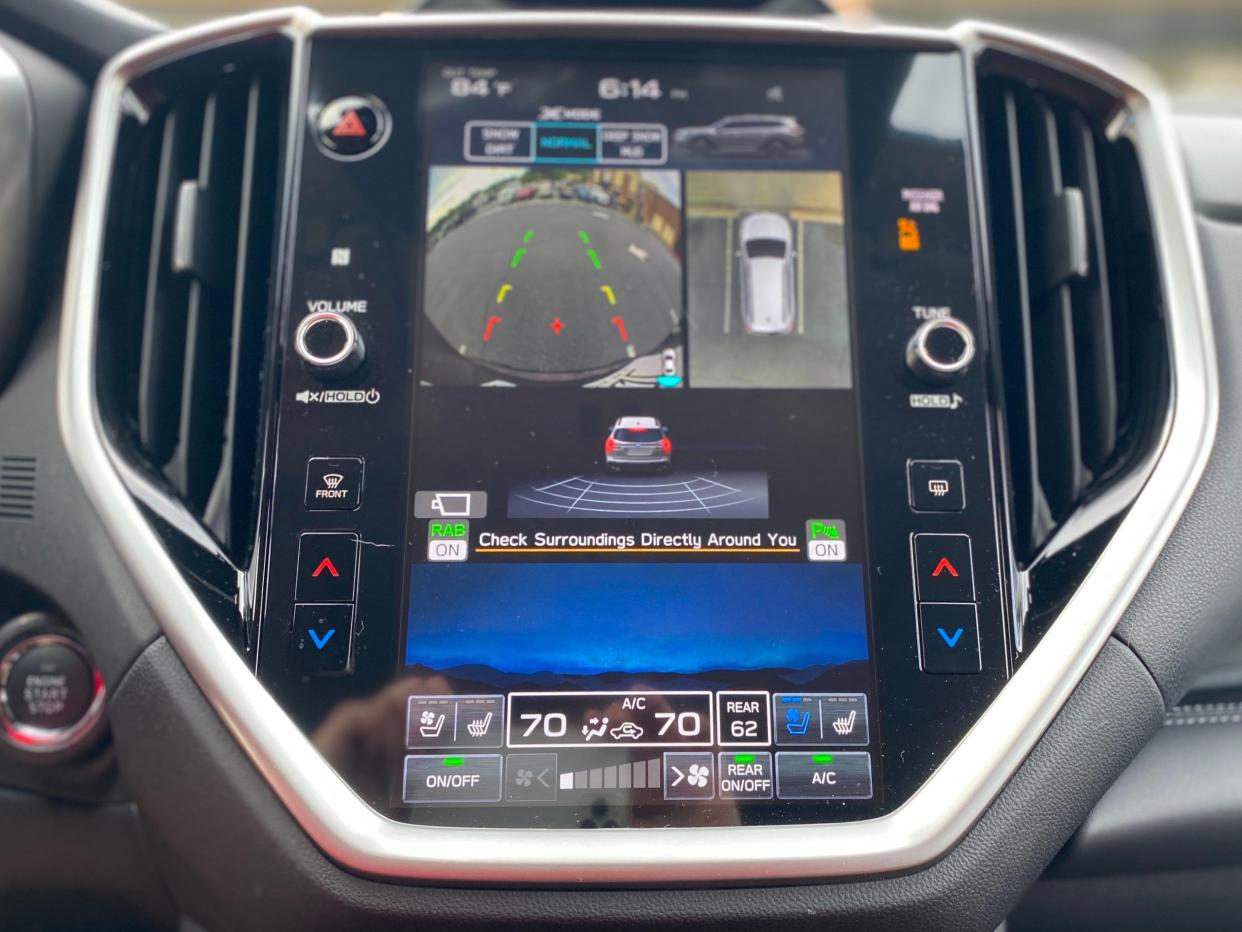 A Subaru Ascent's backup camera displays the vehicle's surroundings in a parking lot on its 11.6-inch infotainment screen.