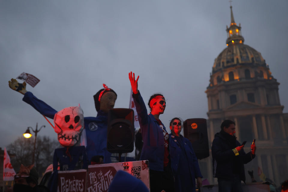 Demonstrators arrive at the Invalides monument during a demonstration against plans to push back France's retirement age, Tuesday, Jan. 31, 2023 in Paris. Demonstrators poured by the thousands into France's streets in the latest clash of wills with the government over its plans to raise the retirement age. Labor unions aimed to mobilize more than 1 million protesters in what one veteran left-wing leader described as a "citizens' insurrection."(AP Photo/Lewis Joly)