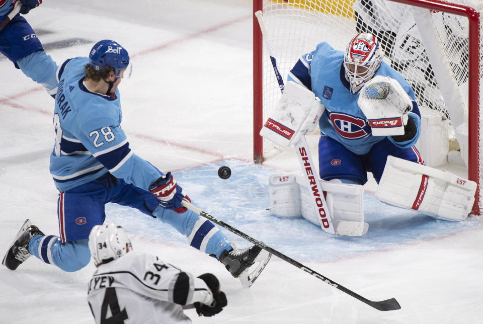 Los Angeles Kings' Arthur Kaliyev (34) shoots on Montreal Canadiens goaltender Jake Allen as Canadiens' Christian Dvorak defends during the third period of an NHL hockey game Saturday, Dec. 10, 2022, in Montreal. (Graham Hughes/The Canadian Press via AP)