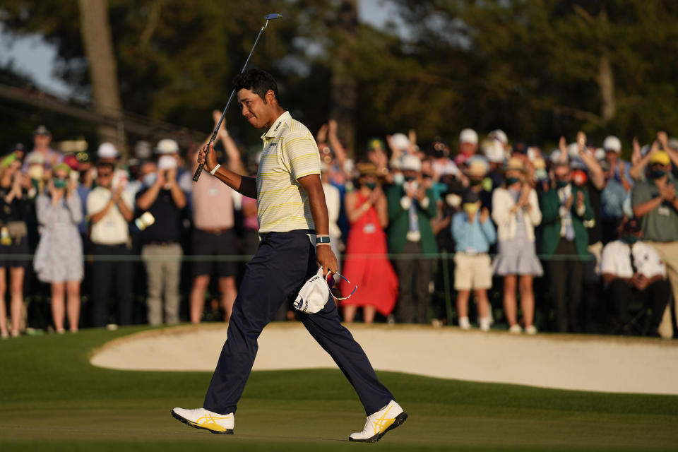 Hideki Matsuyama, of Japan, waves after winning the Masters golf tournament on Sunday, April 11, 2021, in Augusta, Ga. (AP Photo/Matt Slocum)